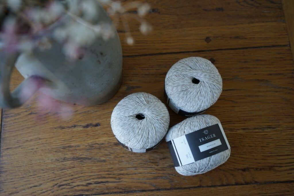three skeins of natural isager bomulin on a table